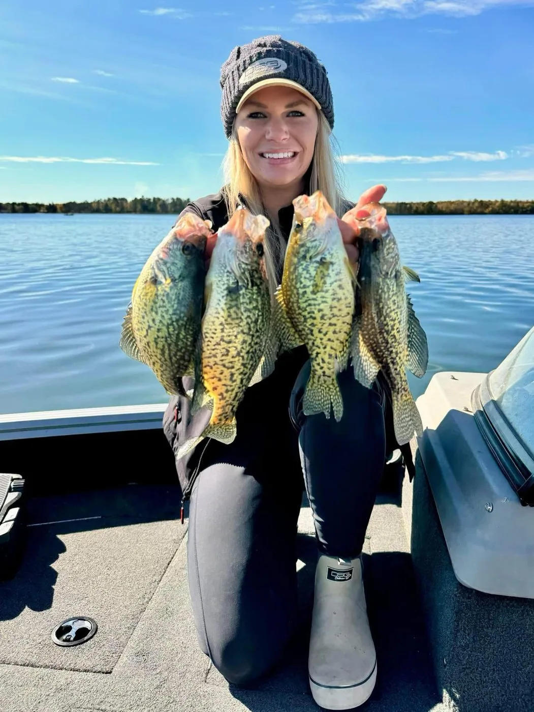 Nicole holding three slab crappie from a boat