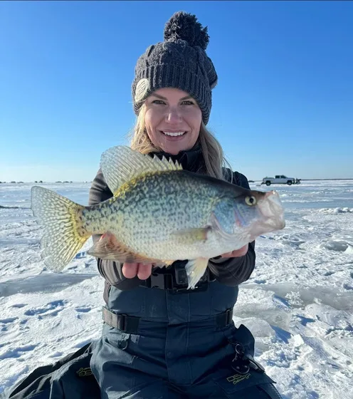 Nicole holding an ice crappie on a sunny day
