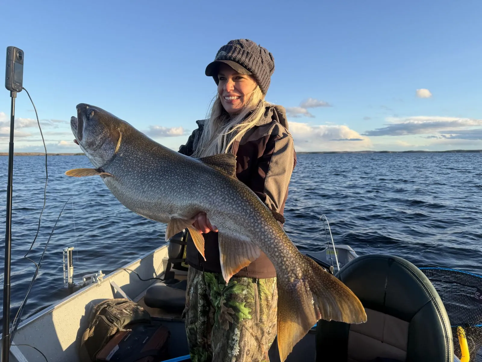 Nicole Stone holding a trophy lake trout on Kamuchawie Lake, a Bakers Narrows Lodge fly-in outpost