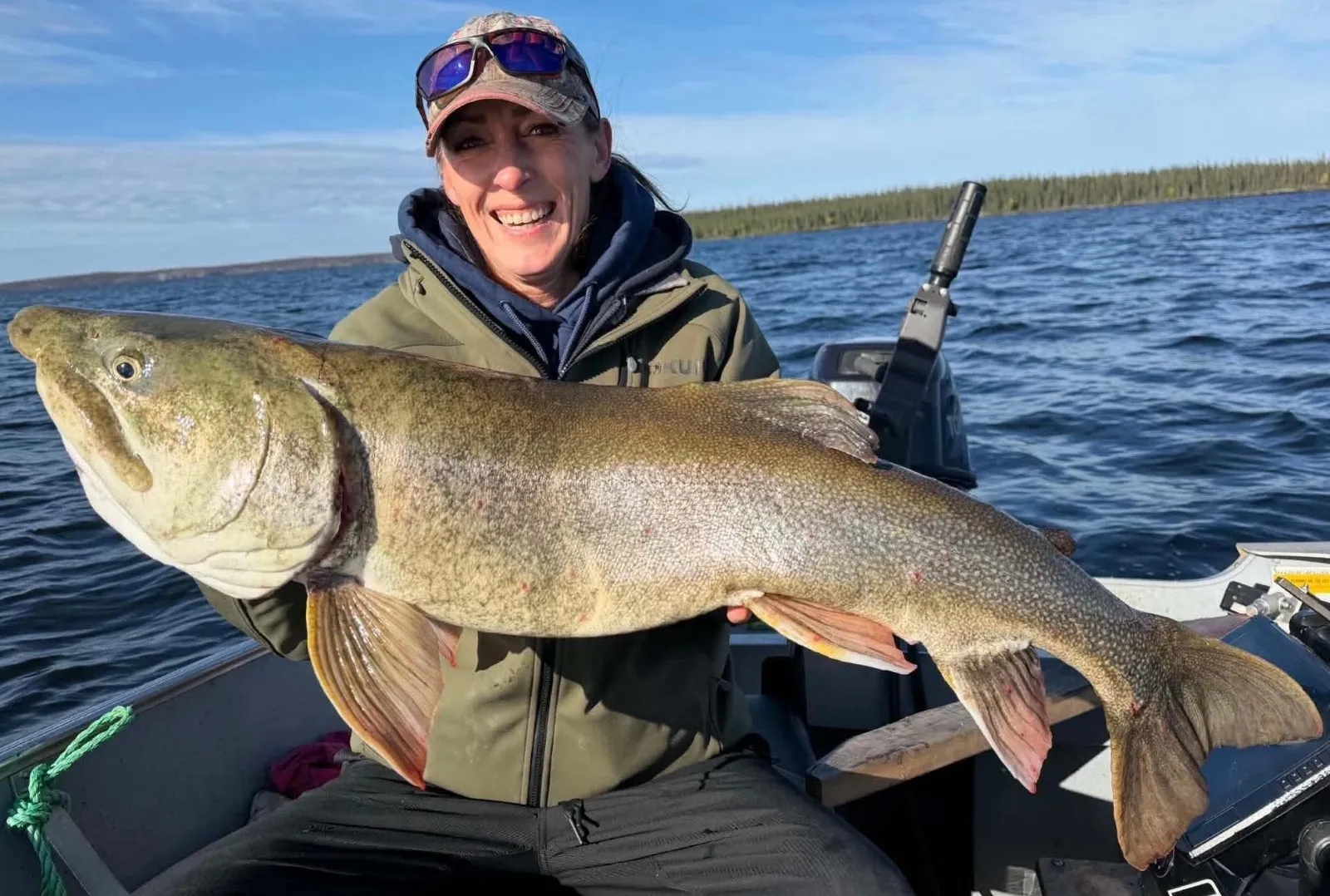 Christina, the outpost cook, holding a trophy lake trout over 40 inches on Kamuchawie Lake